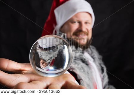 Cheerful Santa Dressed In Fur Skin With Crystal Spehre
