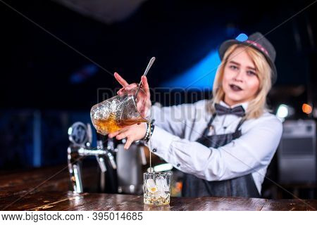Girl Barman Concocts A Cocktail In The Saloon