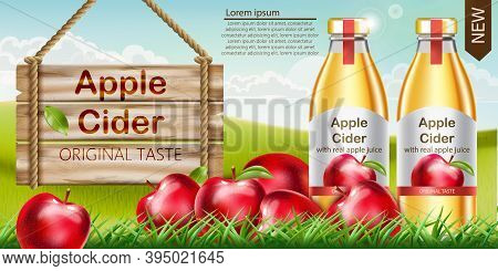 Two Bottles With Golden Liquid Inside Standing On Grass, With Apples Surrounding Them And A Wooden S