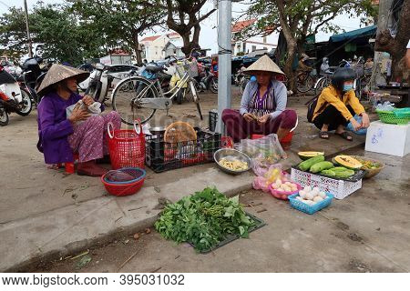 Hoi An, Vietnam, November 16, 2020: Three Women At A Stall In One Of The Streets In The Ba Le Market