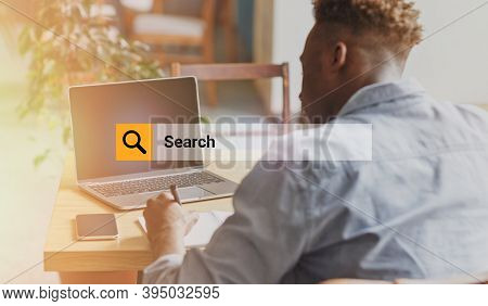 Internet Search Box Over Shot Of African Guy Browsing Websurfing On Laptop Working Online Sitting At