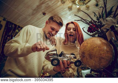 Globe. Smiling Family, Caucasian Couple Looking For Home Decoration And Holidays Gifts In Household 