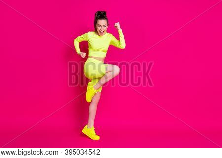 Full Size Profile Photo Of Astonished Young Lady Stand Fists Up Yell Dress Sport Suit Sneakers Isola