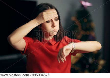 Woman Checking The Time Being Late For Christmas Party