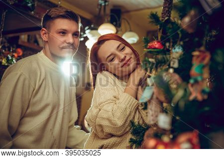 Christmas Tree. Smiling Family, Couple Looking For Home Decoration And Holidays Gifts In Household S