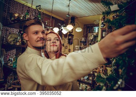 Christmas Tree. Smiling Family, Couple Looking For Home Decoration And Holidays Gifts In Household S