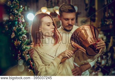 Golden. Smiling Family, Caucasian Couple Looking For Home Decoration And Holidays Gifts In Household