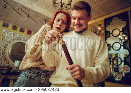 Having Fun. Smiling Family, Caucasian Couple Looking For Home Decoration And Holidays Gifts In House