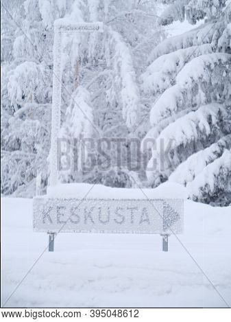Frozen Sign Of Keskusta With Trees In Finland