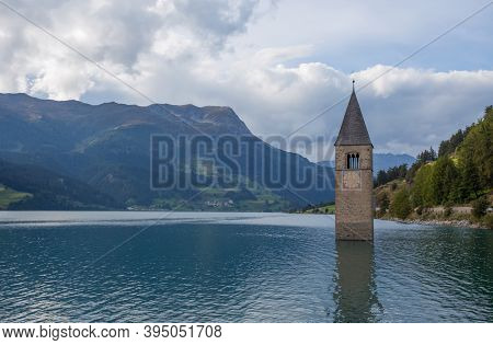 The Bell Tower Of The Sunken Church In Curon, Resia Lake, Bolzano Province, South Tyrol, Italy.