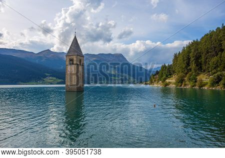 The Bell Tower Of The Sunken Church In Curon, Resia Lake, Bolzano Province, South Tyrol, Italy.