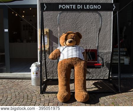 Ponte Di Legno, Italy, September 9, 2020 - A Teddy Bear On A Rocking Chair Outside A Shop In The Vil