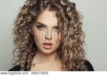 Beautiful Model Woman With Balayage And Curly Hair On White Background Portrait