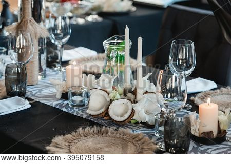 Served Tables For Wedding Banquet With Plates Restaurant. Decor From Fresh Flowers, Coconuts And Lea