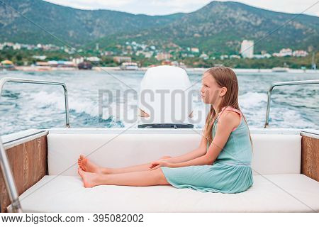 Little Girl Sailing On Boat In Clear Open Sea