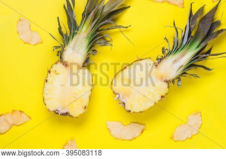 Ripe Juicy Pineapple On Yellow Background And Dried Pineapple Wedges Around. Fruit Chips. Healthy Ea