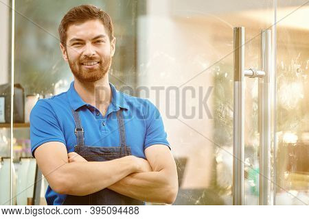 Portrait Of Handsome Confident Coffeshop Owner Standing At Entrance