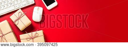 Omline Shopping Concept With Present Boxes, Laptop And Credit Cards At Red Background. Long Banner F