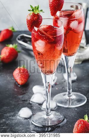 Rossini Alcoholic Cocktail With Italian Sparkling Wine, Strawberry Puree And Ice In Champagne Glasse