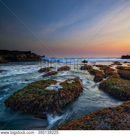Amazing Seascape. Ocean With Moving Wave. Low Lide. Stones Covered By Green Moss And Seaweeds. Conce
