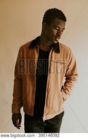 Brown short jacket mockup on African Amercan male model in studio