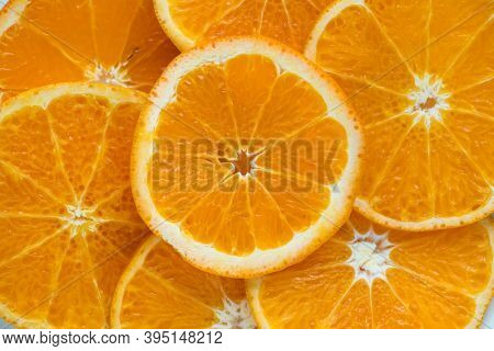 Closeup of sliced juicy oranges textured background