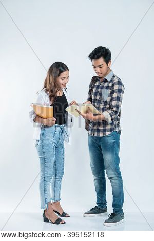 Portrait Young Man Explaining Project On Book To Her Partner