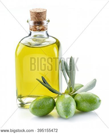 Green natural olives with bottle of olive oil isolated on a white background. 