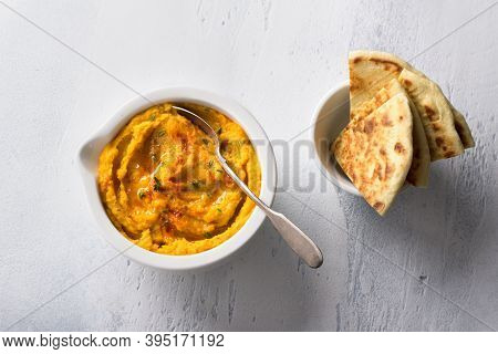 Delicious Healthy Homemade Bean Hummus With Baked Pumpkin, Tahina And Spices With Flat Bread On A Li