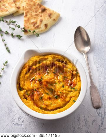 Delicious Healthy Homemade Bean Hummus With Baked Pumpkin, Tahina And Spices With Flat Bread On A Li