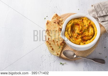 Delicious Healthy Homemade Bean Hummus With Baked Pumpkin, Tahina And Spices With Flat Bread On A Li