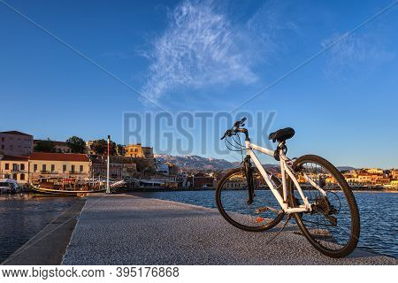 Early Morning In Old Venetian Port, Chania, Crete, Greece. Close-up Of Bicycle On Pier. Bicycle Tour