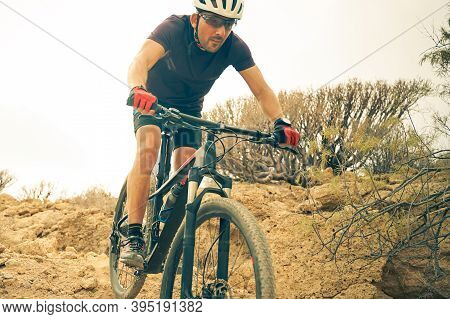 Cyclist In Violet Riding The Mountain Bike On The Spring Enduro Trail. Extreme Sport And Enduro Biki