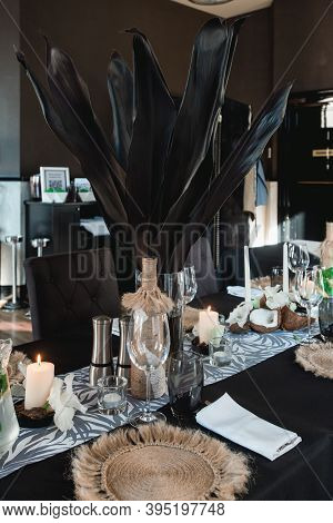 Served Tables For Wedding Banquet With Plates Restaurant. Decor From Fresh Flowers, Coconuts And Lea