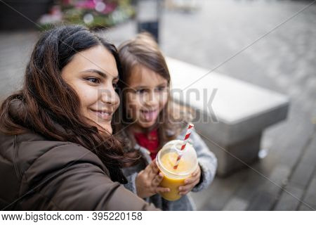 Mother And Daughter Taking A Selfie While Making Funny Faces
