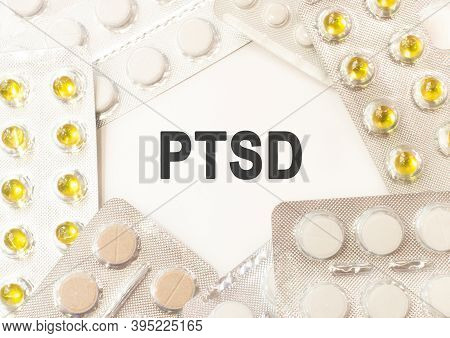 Posttraumatic Stress Disorder. Text Ptsd On White Background. There Are Various Pills And Vitamins A