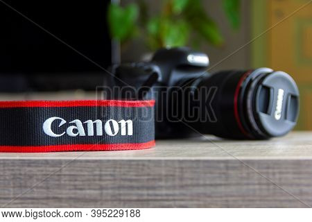 Brecht, Belgium - April 30 2020: A Portrait Of A Camera Strap Of The Canon Company Lying On A Table 
