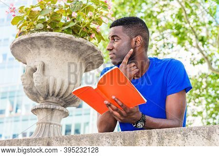 Young African American College Student Studying In New York City, Wearing Blue Short Sleeve T Shirt,