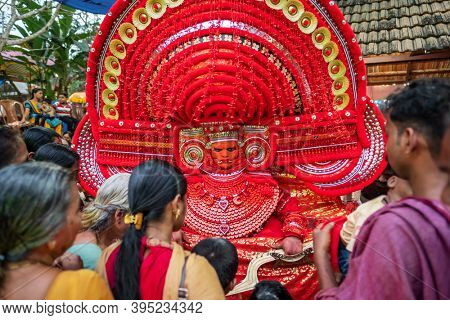 Kannur, India - December 2, 2019: Theyyam artist perform during temple festival in Kannur, Kerala, India. Theyyam is a popular ritual form of worship in Kerala, India
