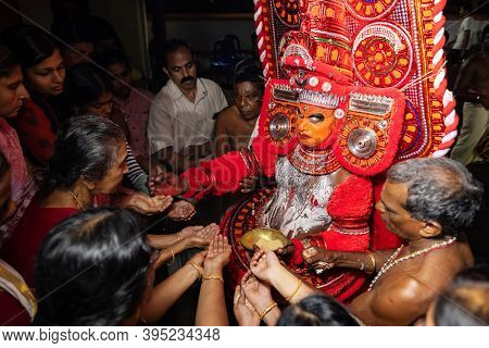 Payyanur, India - December 5, 2019: Theyyam artist perform during temple festival in Payyanur, Kerala, India. Theyyam is a popular ritual form of worship in Kerala, India