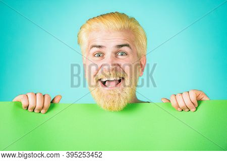 Smiling Man Holding Empty Blank Paper Board With Copy Space For Text. Man Holding Big Sign Board. Ha