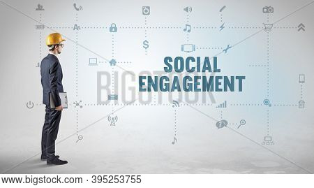 Engineer working on a new social media platform with SOCIAL ENGAGEMENT inscription concept
