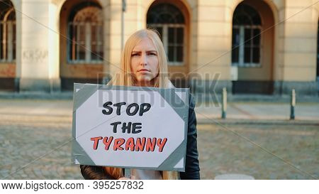 Young Woman Calling To Stop The Tyranny By Holding Steamer. Protest Walk In The City Center.