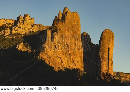 Mountains Of The Mallos De Riglos, Vertical Rock Walls At Sunset, A Famous Place For Climbing Near T