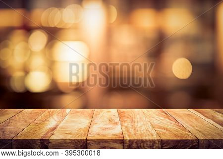 Wood Table Top (bar) With Blur Light Bokeh In Dark Night Cafe,restaurant Background.no People