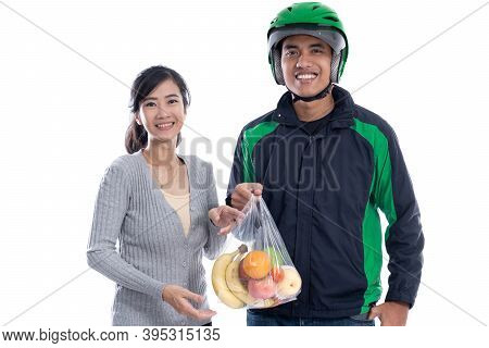 Asian Delivery Courier Delivering Food To Female Customer