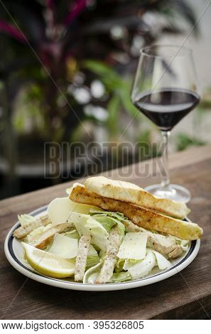 Simple Healthy Orgaanic Chicken Caesar Salad On Wood Table