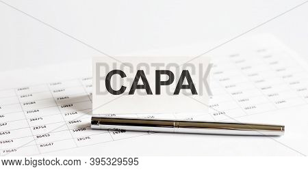Text Capa On Stickers,pen On The Background Of Documents. Financial Bookkeeping, Accounting Concept.