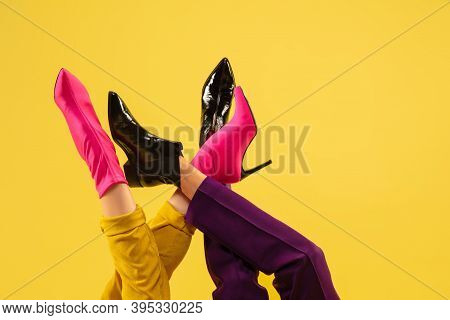 Jocosity. Fashion Model's Feet In Bright Stylish Footwear White, Pink Isolated On Yellow Background.