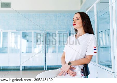 Medicine And Healthcare Concept. Female Doctor Surgeon Working At Surgery Room And Smiling At Camera